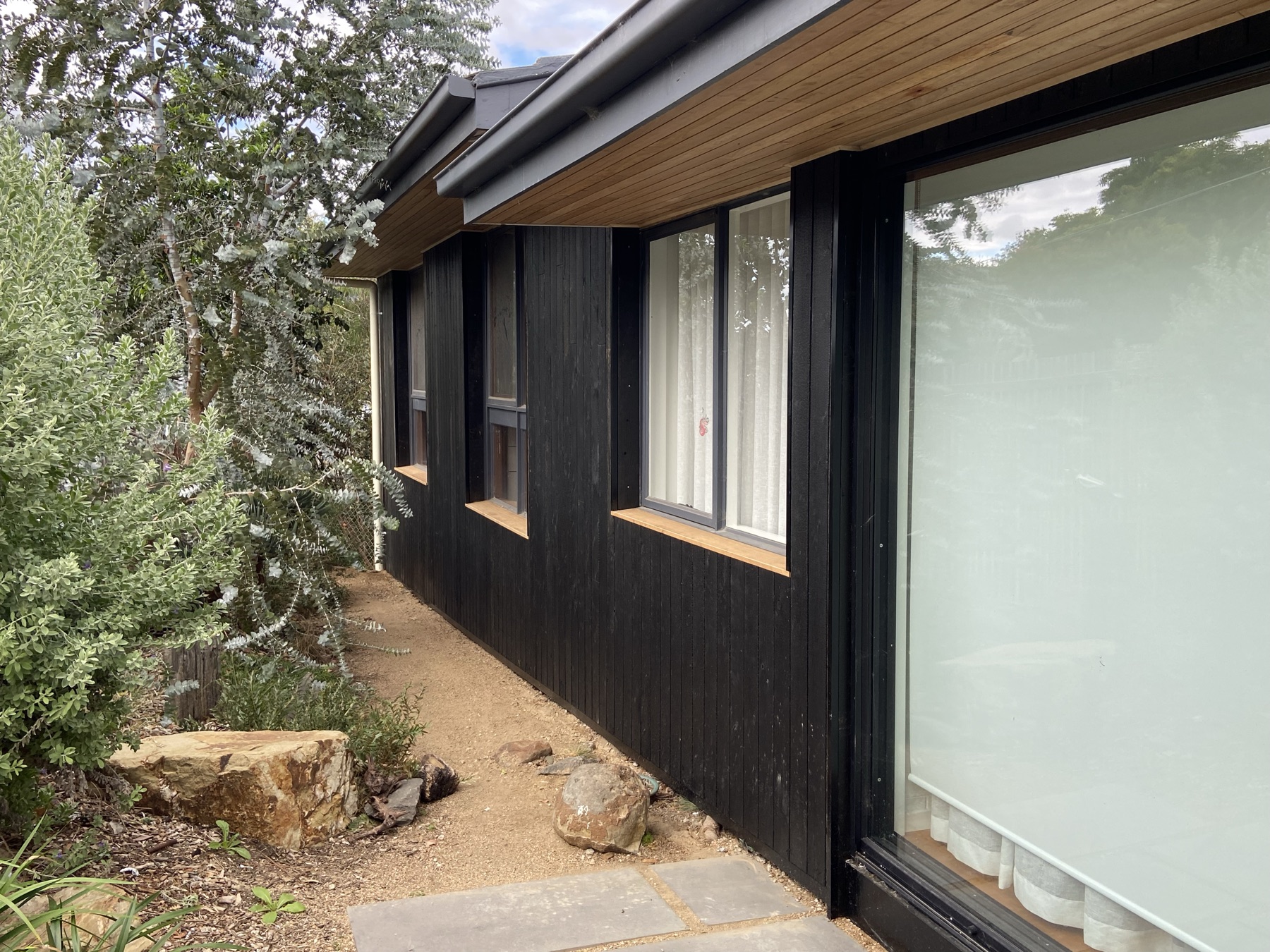 Dark timber cladding detail on completed exterior renovation