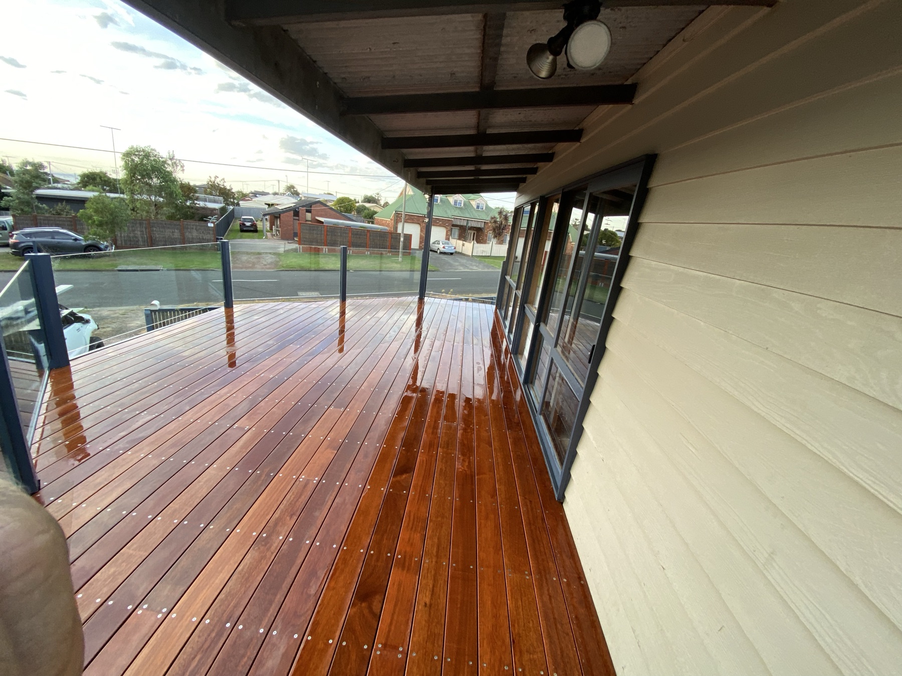 Elevated hardwood deck with glass balustrade