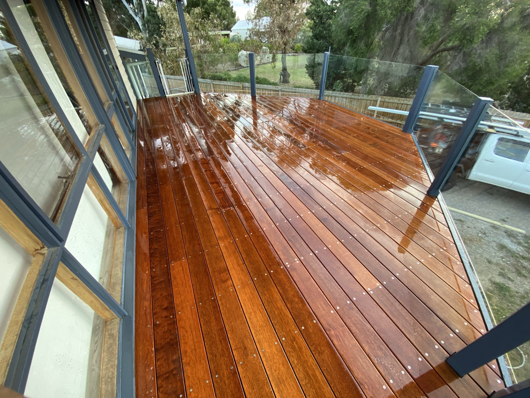 Elevated timber deck with glass balustrade panels